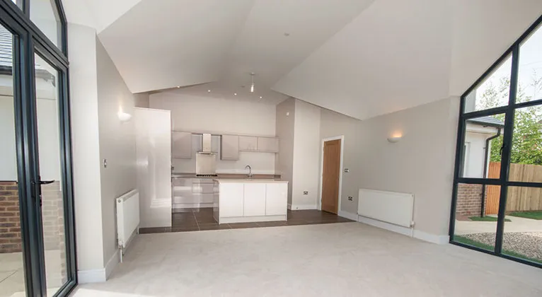 an empty living room with a large window